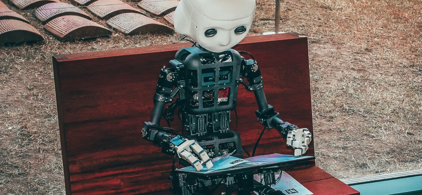 Robot typing on a laptop